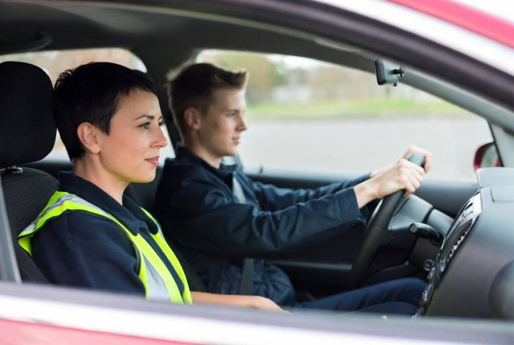 Female driving instructor teaching a learner driver in a dual control car